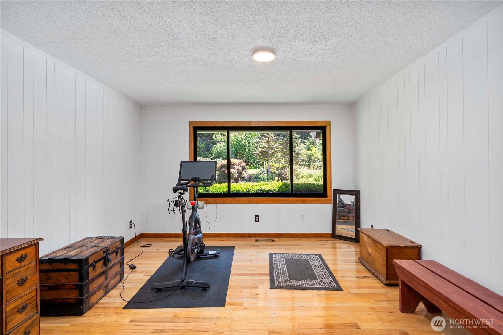 Gorgeous 2019 windows framed in VG fir enhance this room currently being used as an office by the owners.  It has a wet bar and could also serve as a formal dining room.