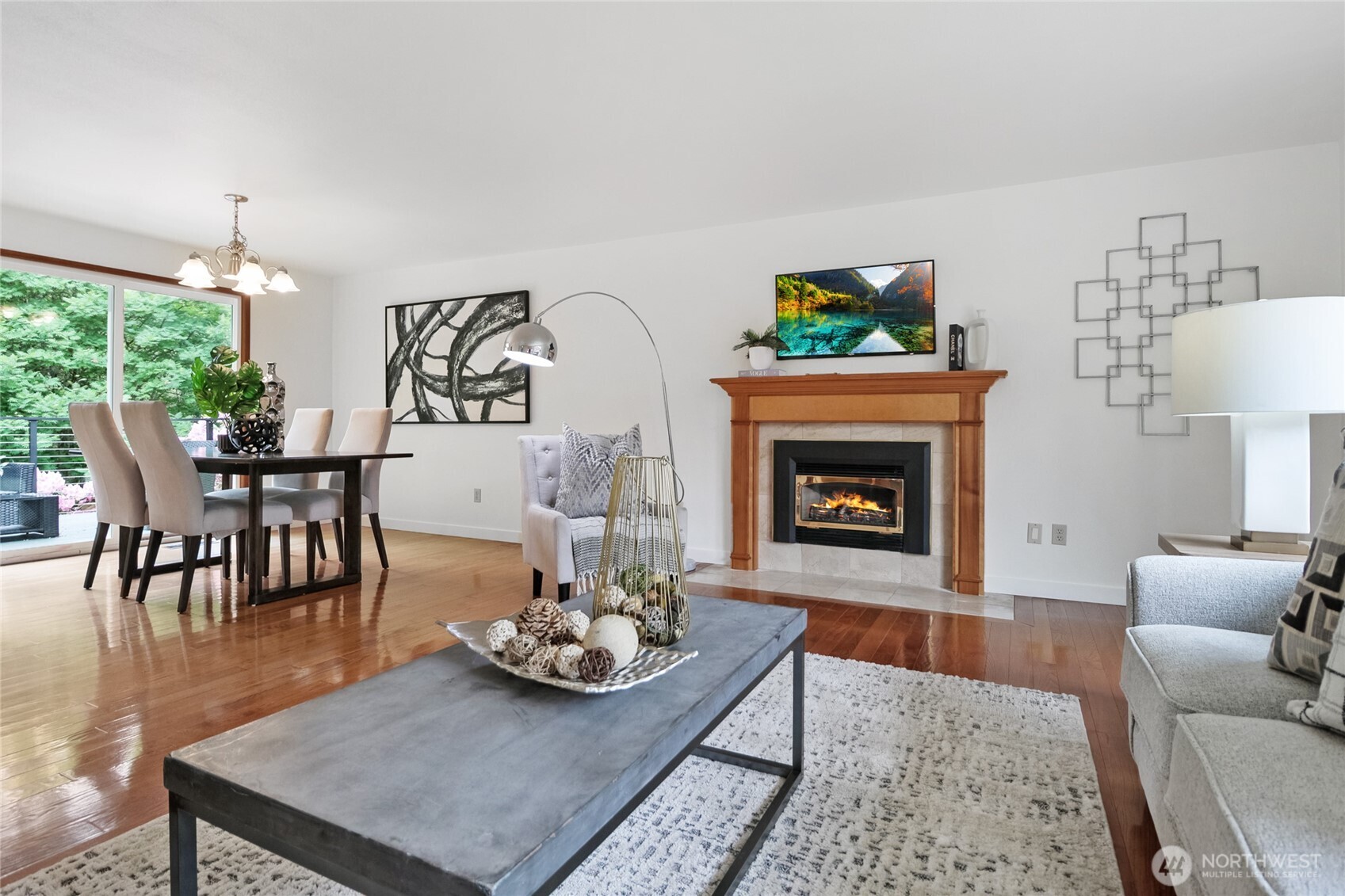 The spacious living room, complete with a cozy gas fireplace, is perfect for gatherings or quiet evenings