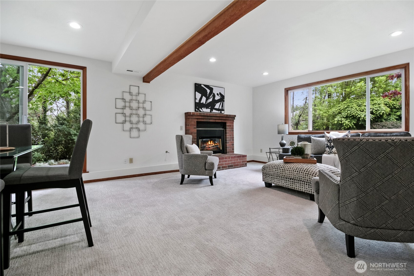 Enjoy the spacious lower-level family room, perfect for entertaining or unwinding by the gas fireplace. A sliding glass door provides seamless access to the inviting side yard deck.