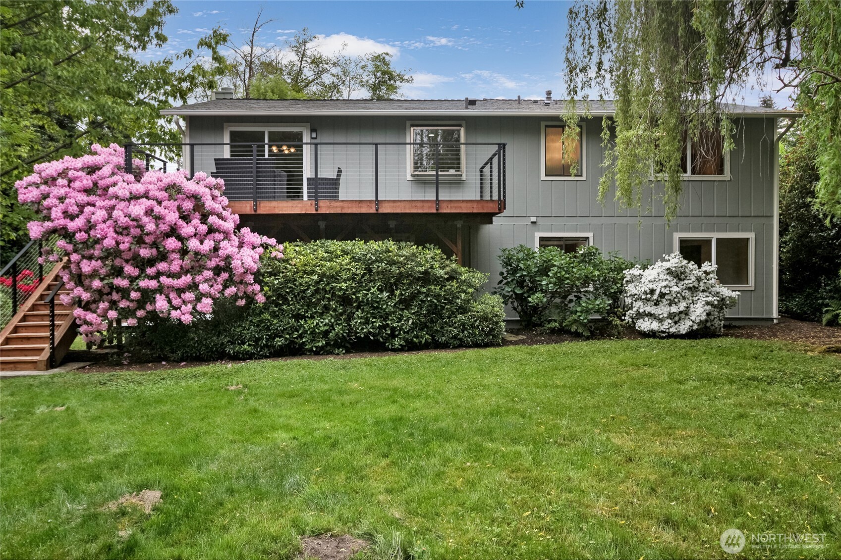 Covered with large Rhodedrum flowers in in the spring with full bloom just off the corner of the large entertainment deck. GREAT for entertaining.
