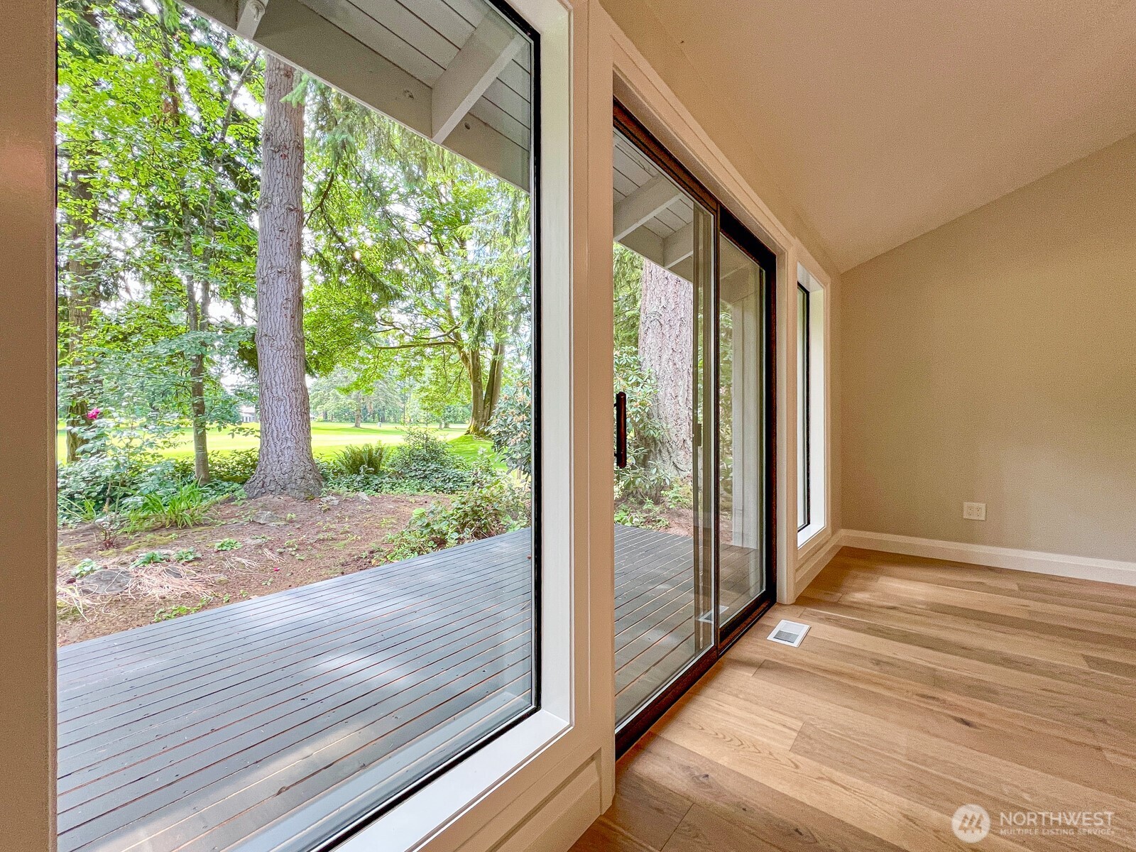 Primary Bedroom with private deck viewing the golf course