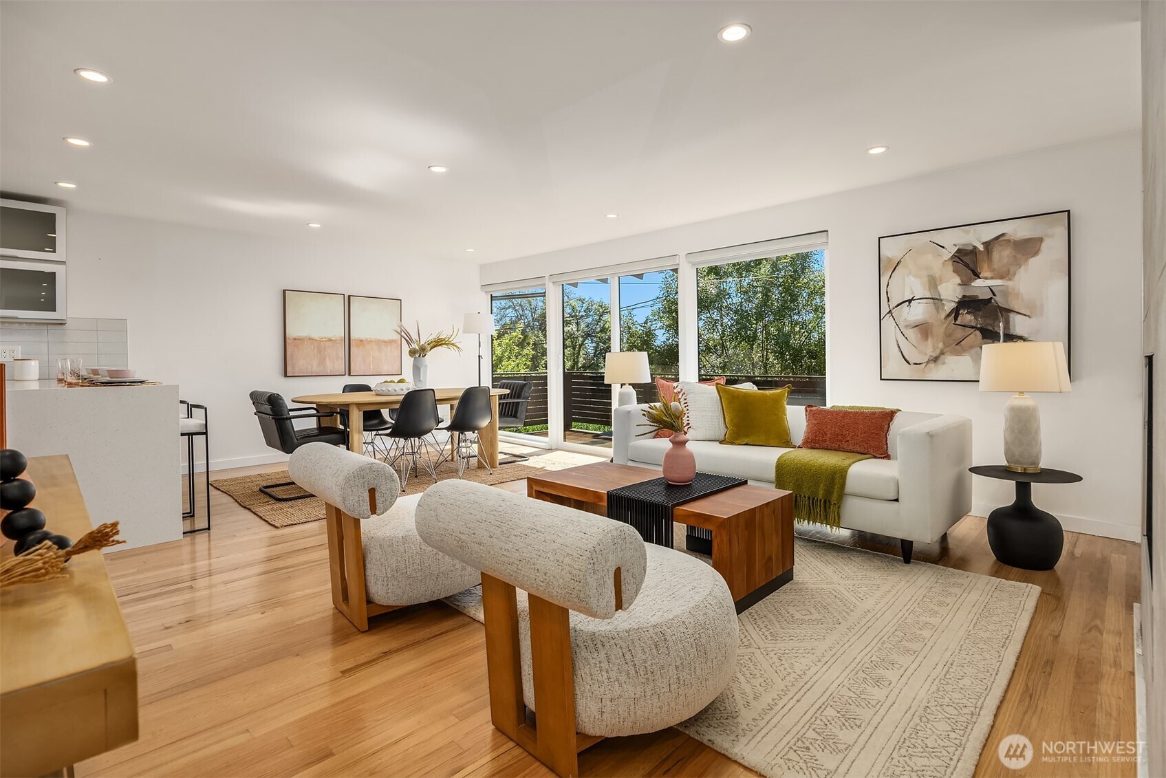 Stunning open-concept layout in the spacious, west-facing living room, seamlessly connected to the kitchen and opening onto a private balcony—perfect for effortless entertaining and sunset views.