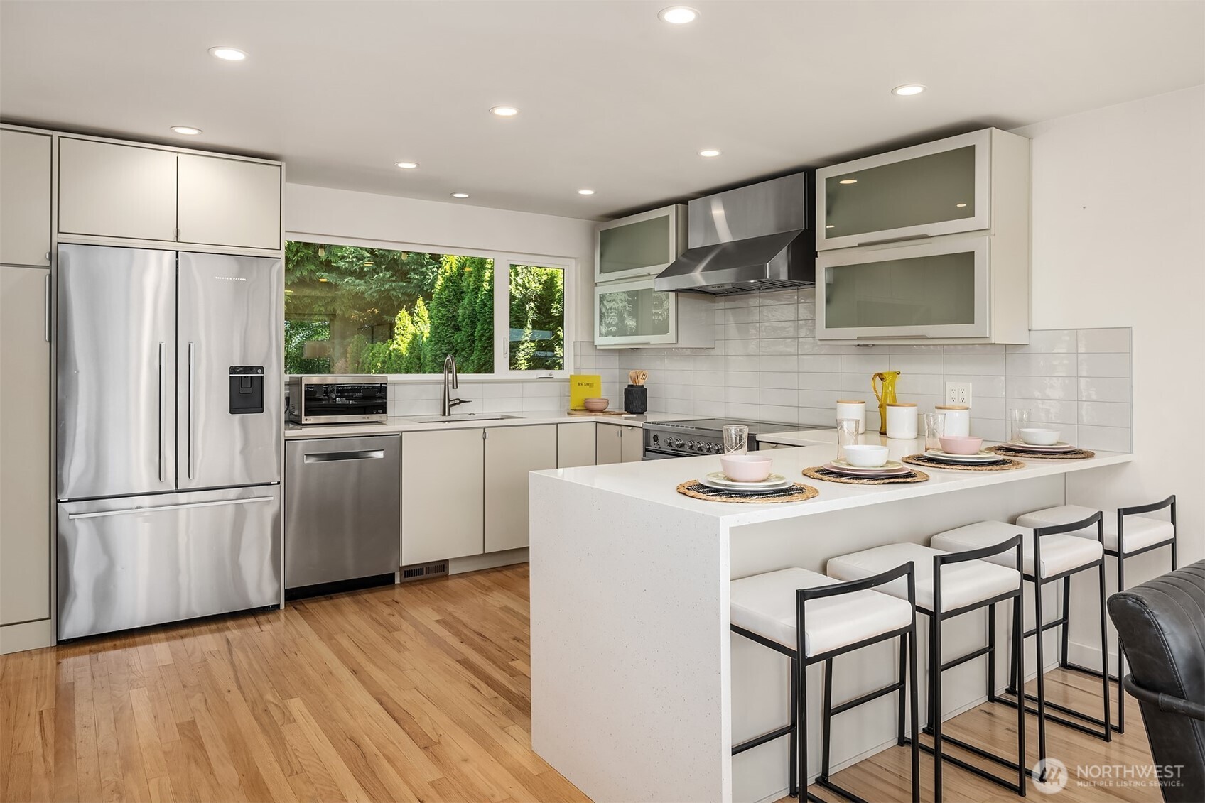 Light-filled kitchen featuring an oversized picture window above the sink that frames serene views of the expansive backyard—perfect for enjoying the outdoors while cooking or entertaining.