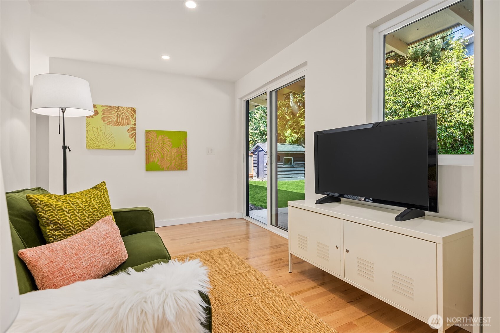 Just off the kitchen, a cozy hangout space is perfect for relaxing while dinner simmers—or step through the sliding glass doors for seamless access to the backyard for play!