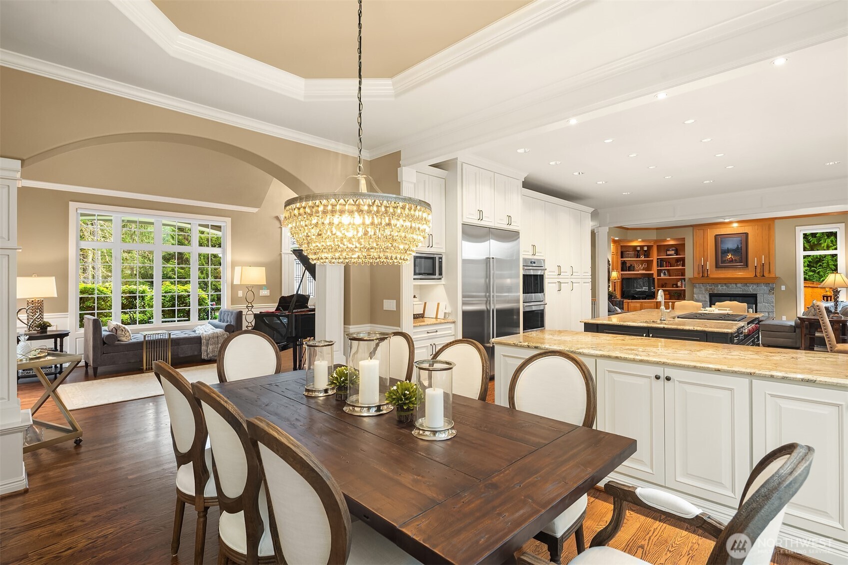 Beautiful wood floors throughout the main level. The floorplan provides flexible and comfortable living, including a den/office and upper-floor bonus room with surround sound. Dual staircases provide easy access to the upper level.