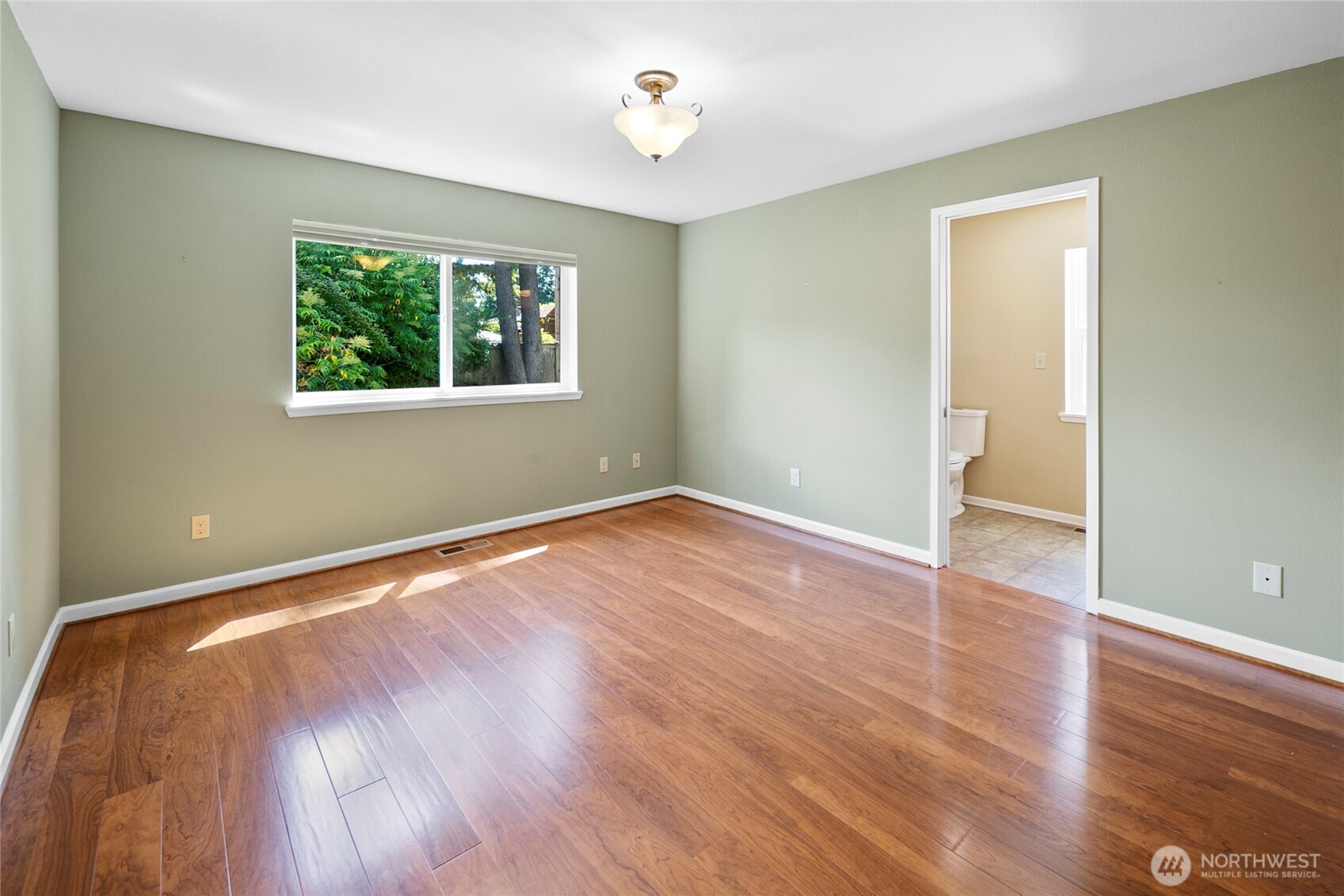 The primary bedroom unstaged still feels serene and generously sized.