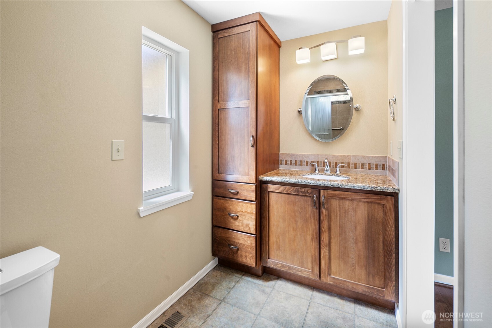 The primary ensuite bath features fresh tile, modern fixtures, and a walk-in shower—stylish and functional.