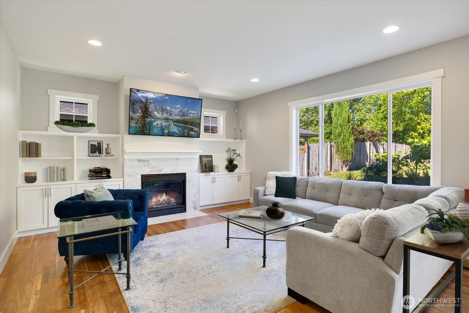 Enjoy the family room off the kitchen and informal dining room with it's wall of built-in storage and huge windows to the backyard retreat.