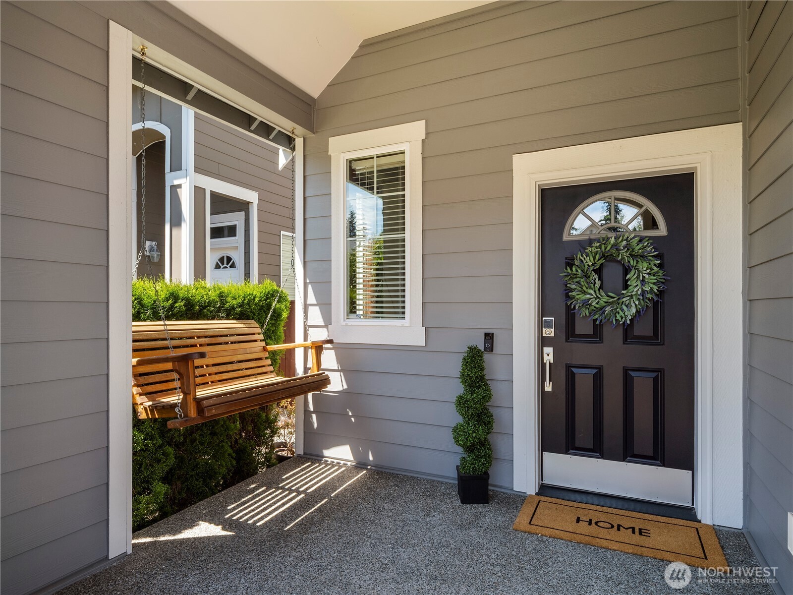 ...and inviting front porch, swing included!