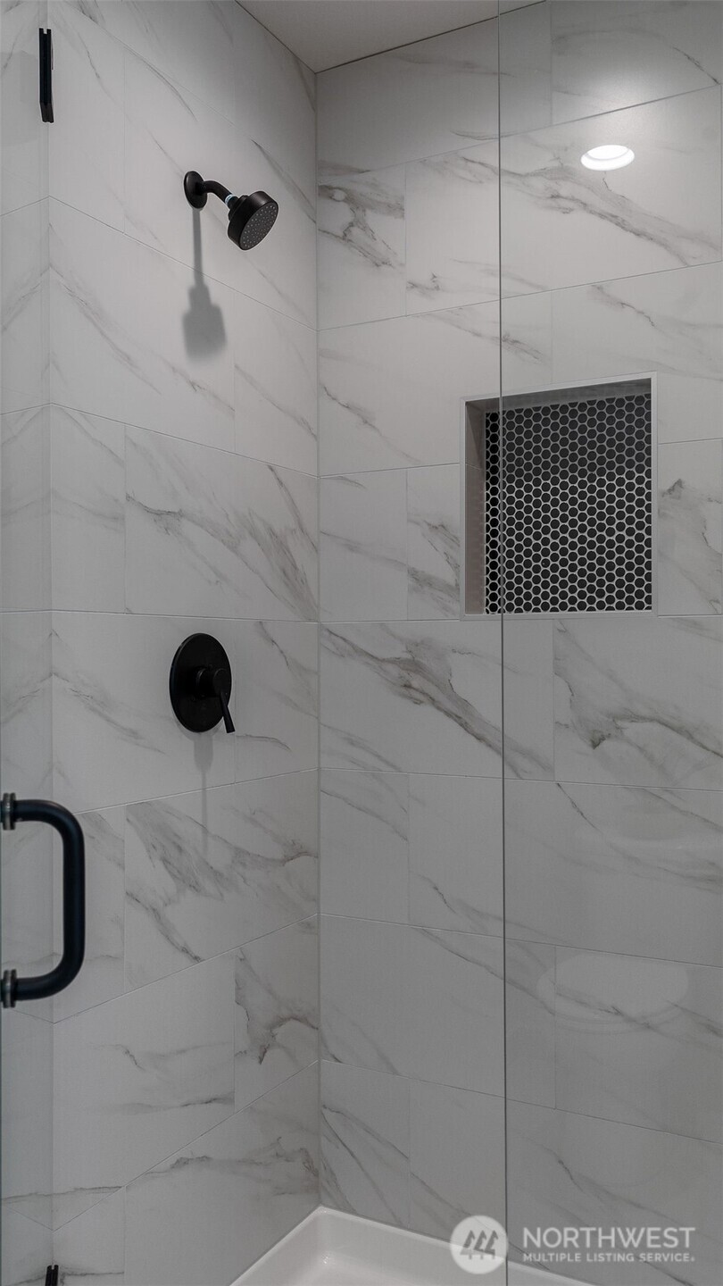 Fully tiled shower in Primary.