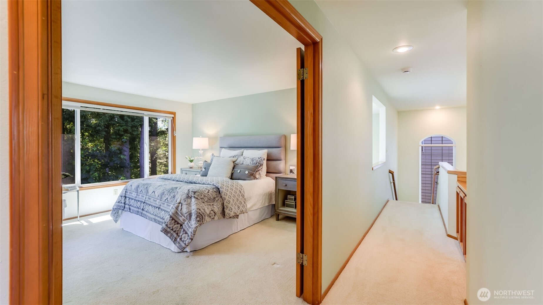 Looking into the primary suite through the wide open double doors.