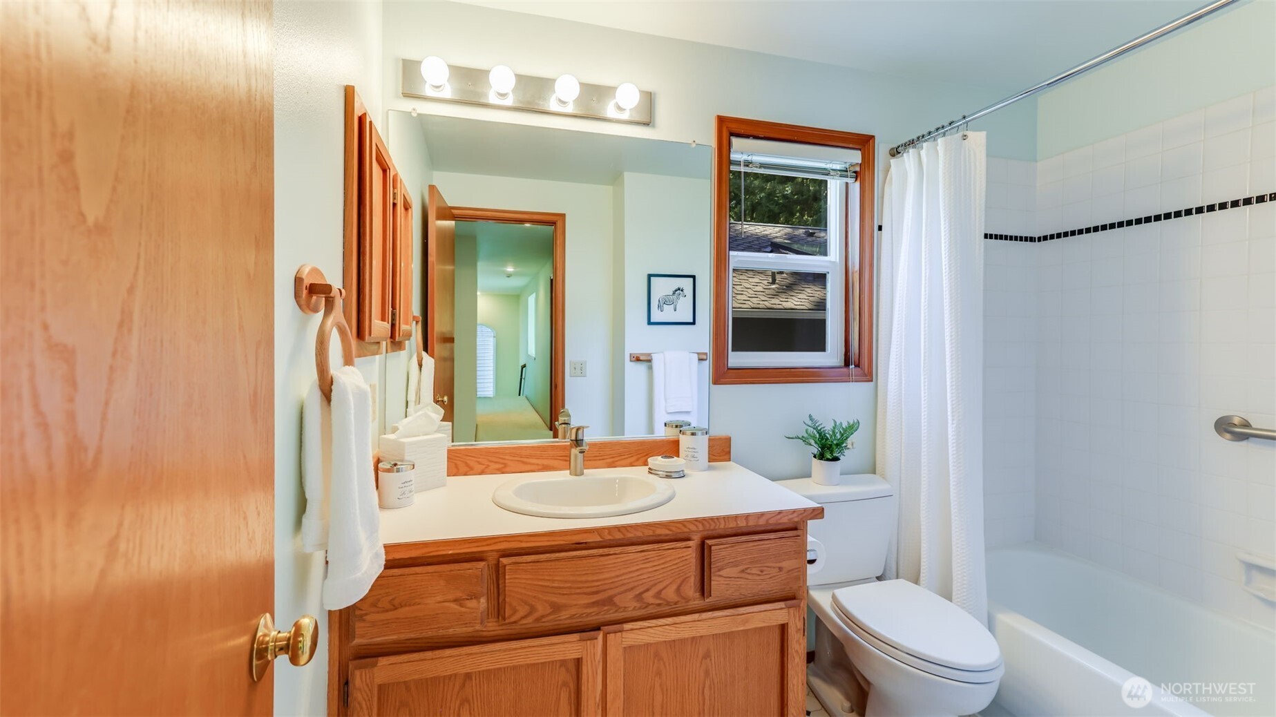 The full hall bath is at the end of the hallway.