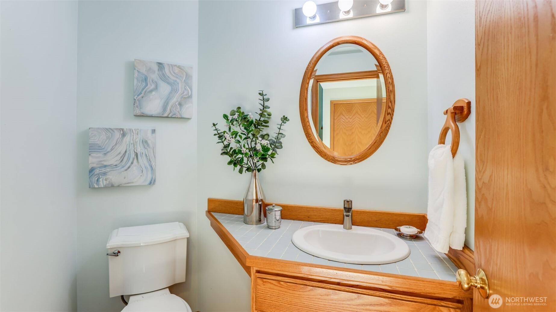 The powder room is between the dining/living rooms and the family room/kitchen.