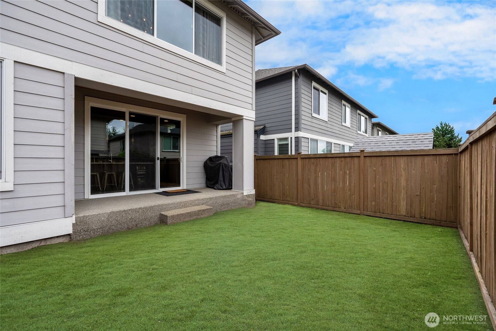 Covered outdoor living area just off the Kitchen (**Digitally Altered Photo - Sod is not currently present. Seller to credit buyer $1,800 for sod installation. Tempature has been to warm to install properly)
