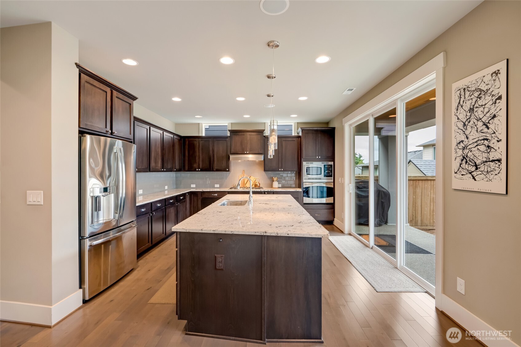 Stunning Chef's Kitchen with Expansive Granite Slab Island.