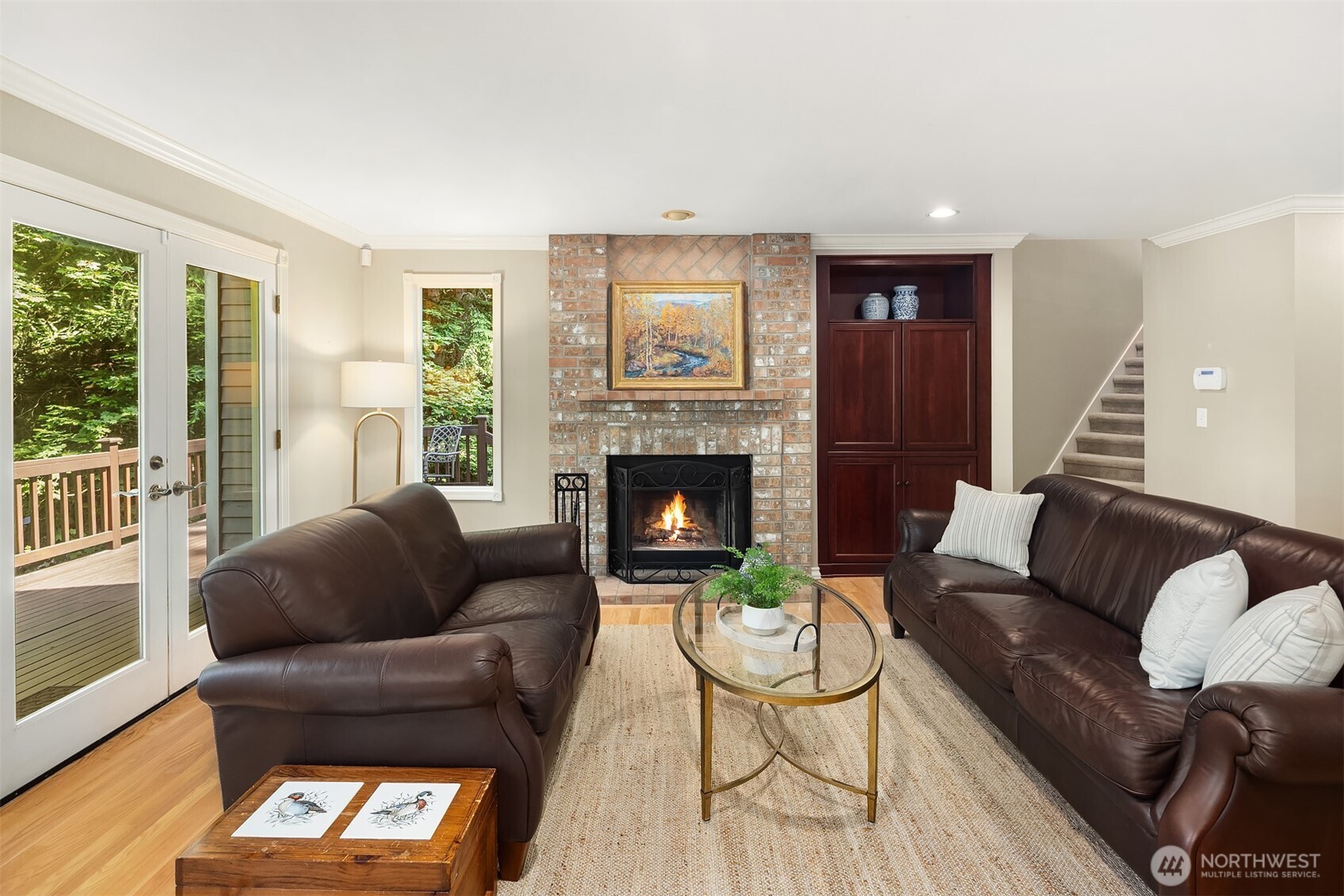 A wonderfully cozy family room with built in media center, & adjacent deck for outdoor entertaining