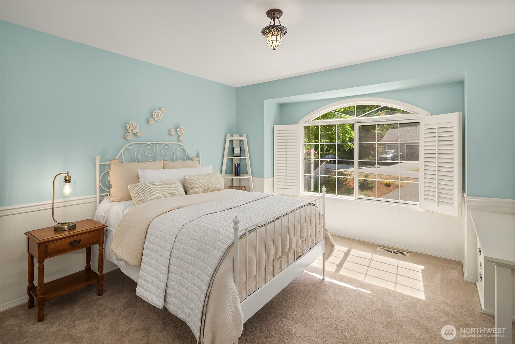 One of two secondary bedrooms in this wing of the house, with plantation shutters.