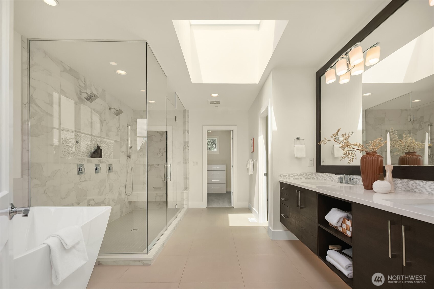 Your luxe 5-piece en-suite bath features heated floors, a bright skylight & separate commode room.