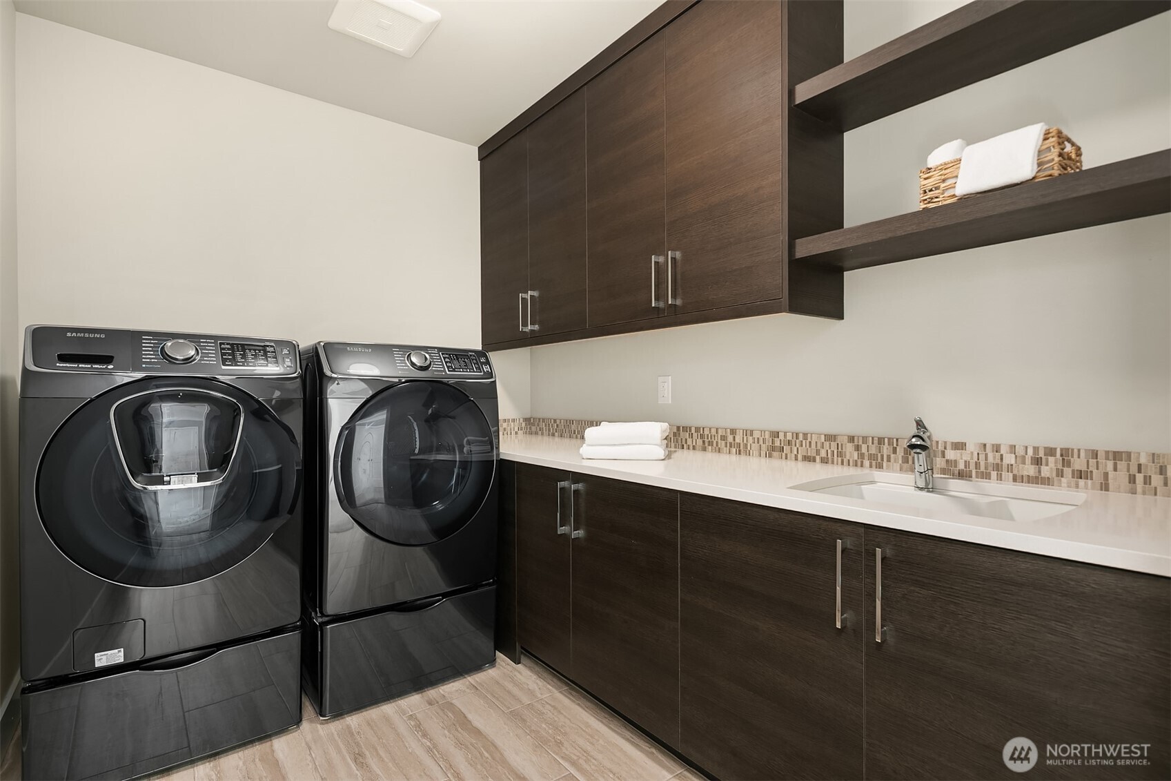 Convenient upper-level laundry with wonderful storage & undermount utility sink.