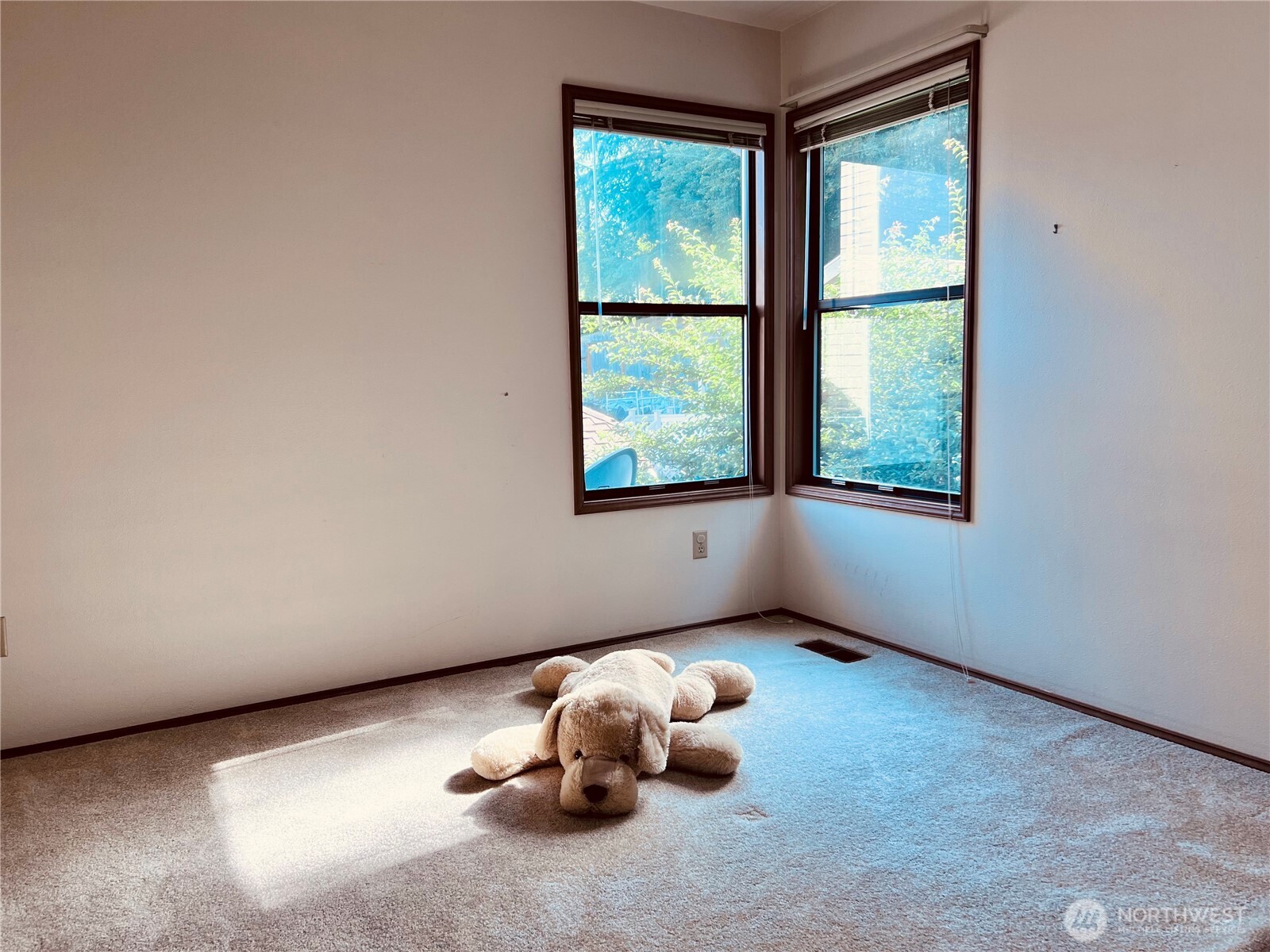 Bedroom 3 in upper SE corner of home facing southeast with two windows. Large closets.