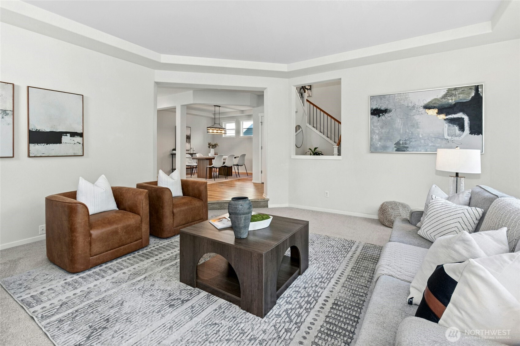 The space is at once voluminous and cozy, and also affords a peek into the adjoining entry and dining rooms.