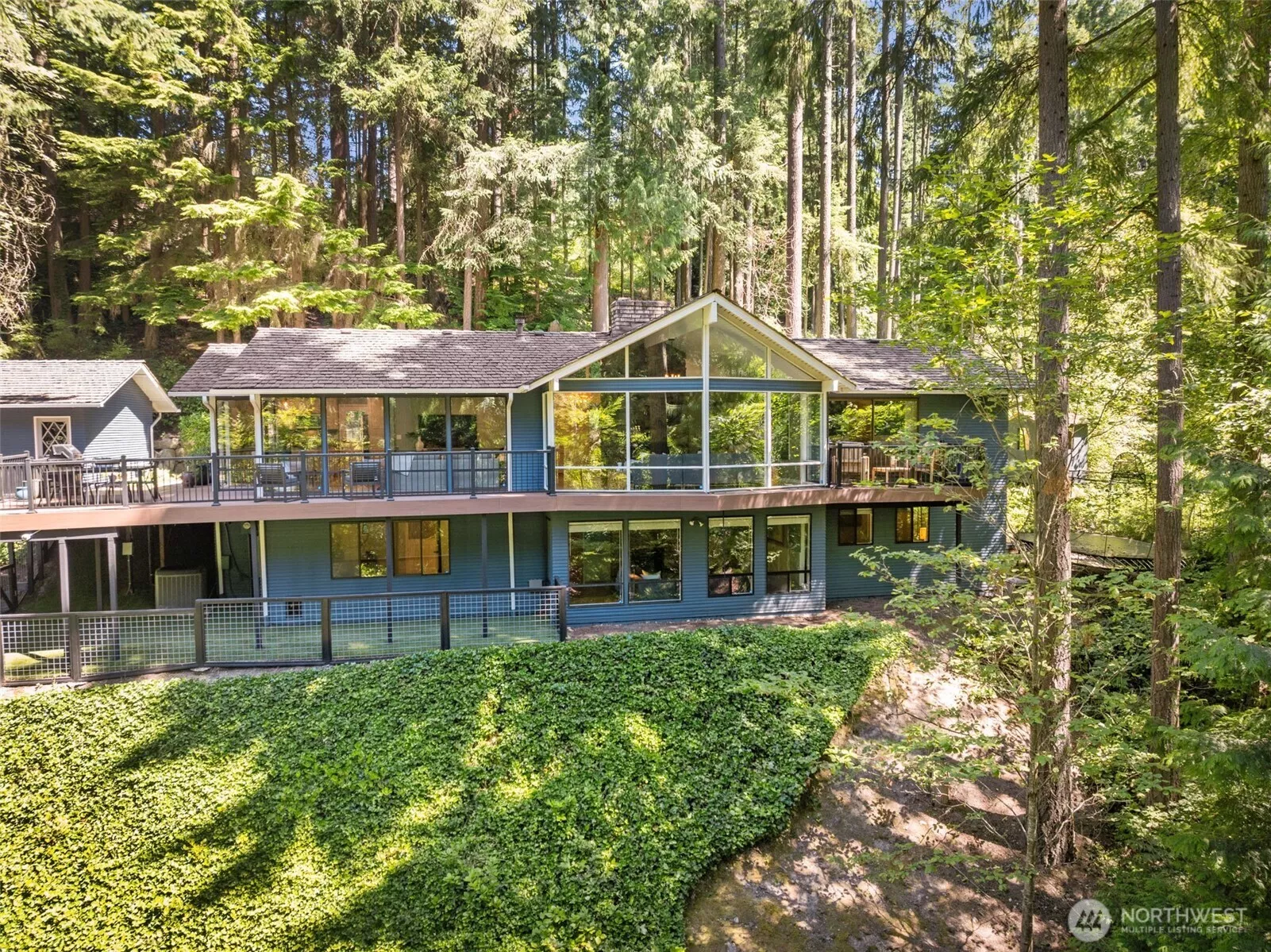 A true retreat—nestled among the trees and thoughtfully designed for elevated, effortless living. Walls of windows and seamless outdoor access connect every space to the surrounding beauty.