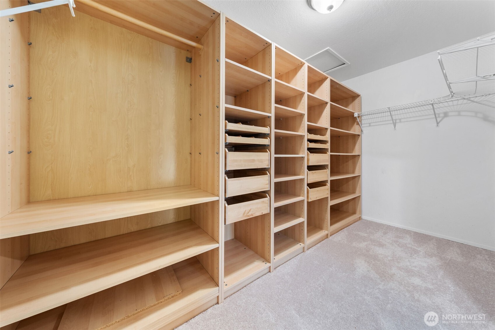A truly expansive walk-in closet with custom shelving and ample storage—designed to keep everything beautifully organized.