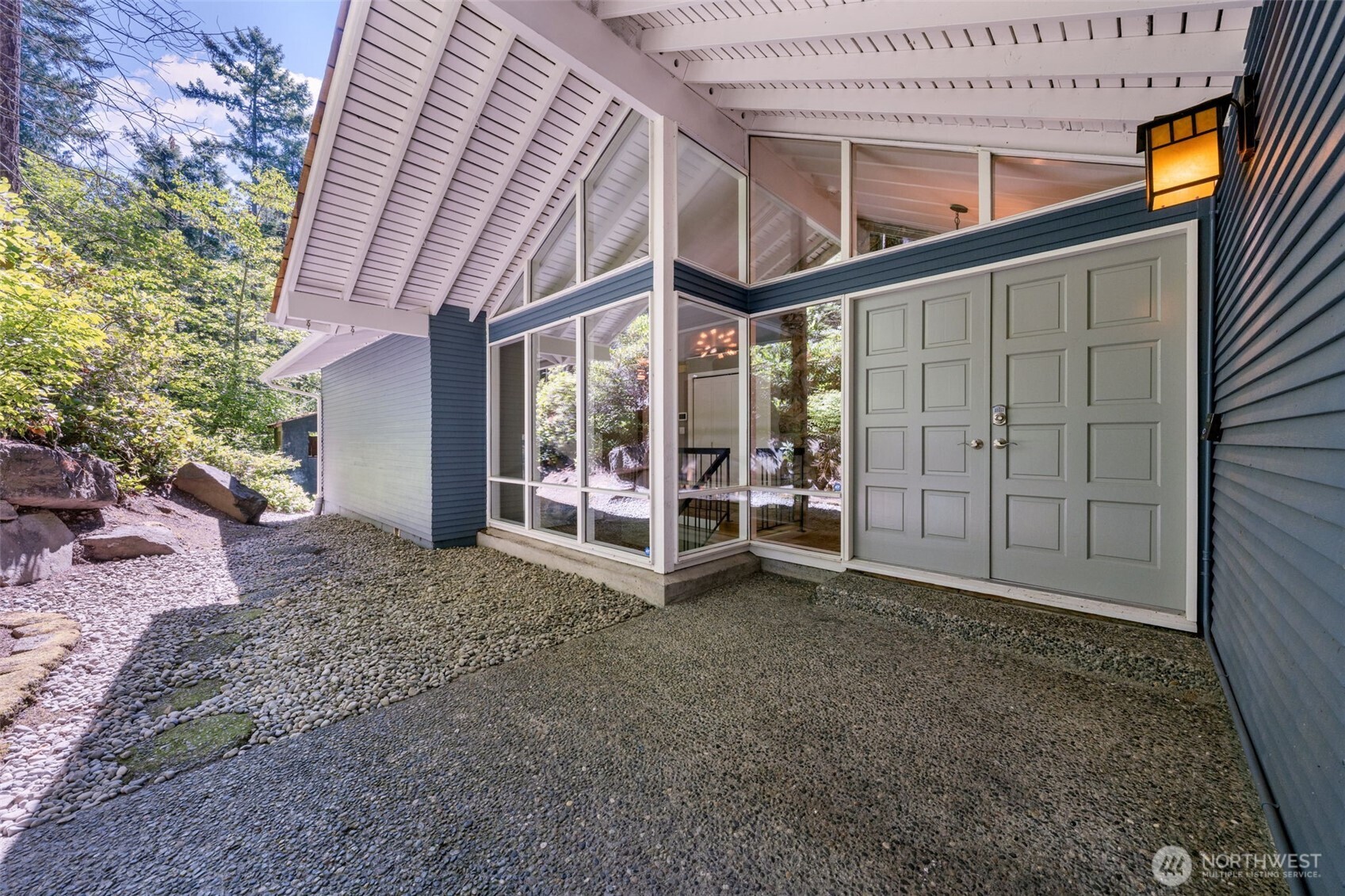 A striking double-door entrance makes a lasting first impression. Framed by dramatic floor-to-ceiling windows, this is a grand yet peaceful welcome into the heart of the home.
