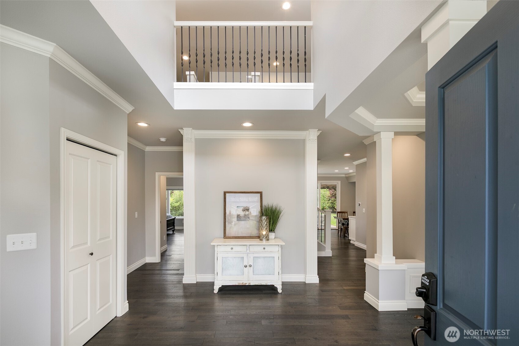 Step in to 2-story entryway with open rail balcony; hardwood floors; freshly painted interior & extensive millwork