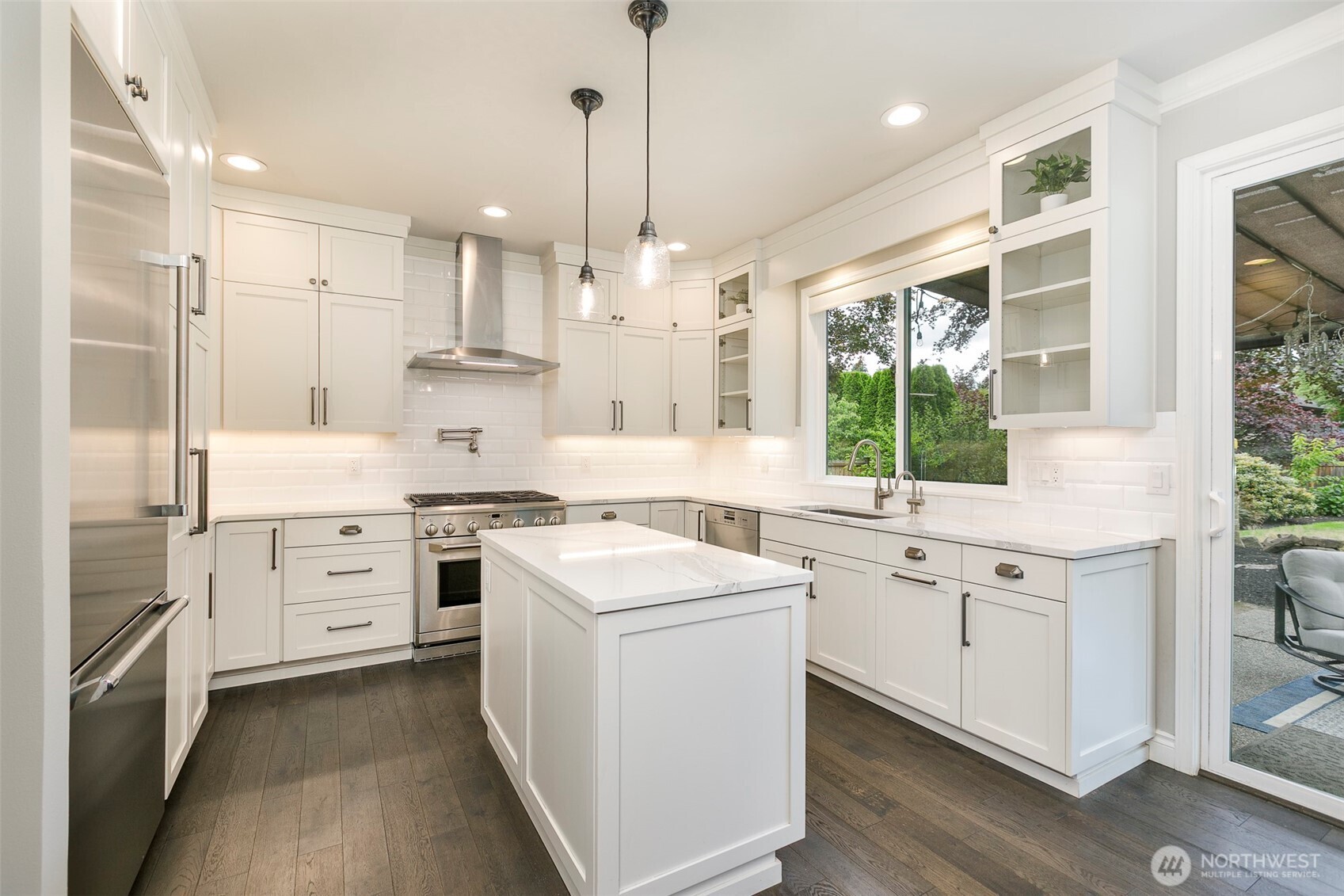 Quartz counters, custom depth upper cabinets, upgraded appliance package & even a stove top pot faucet.