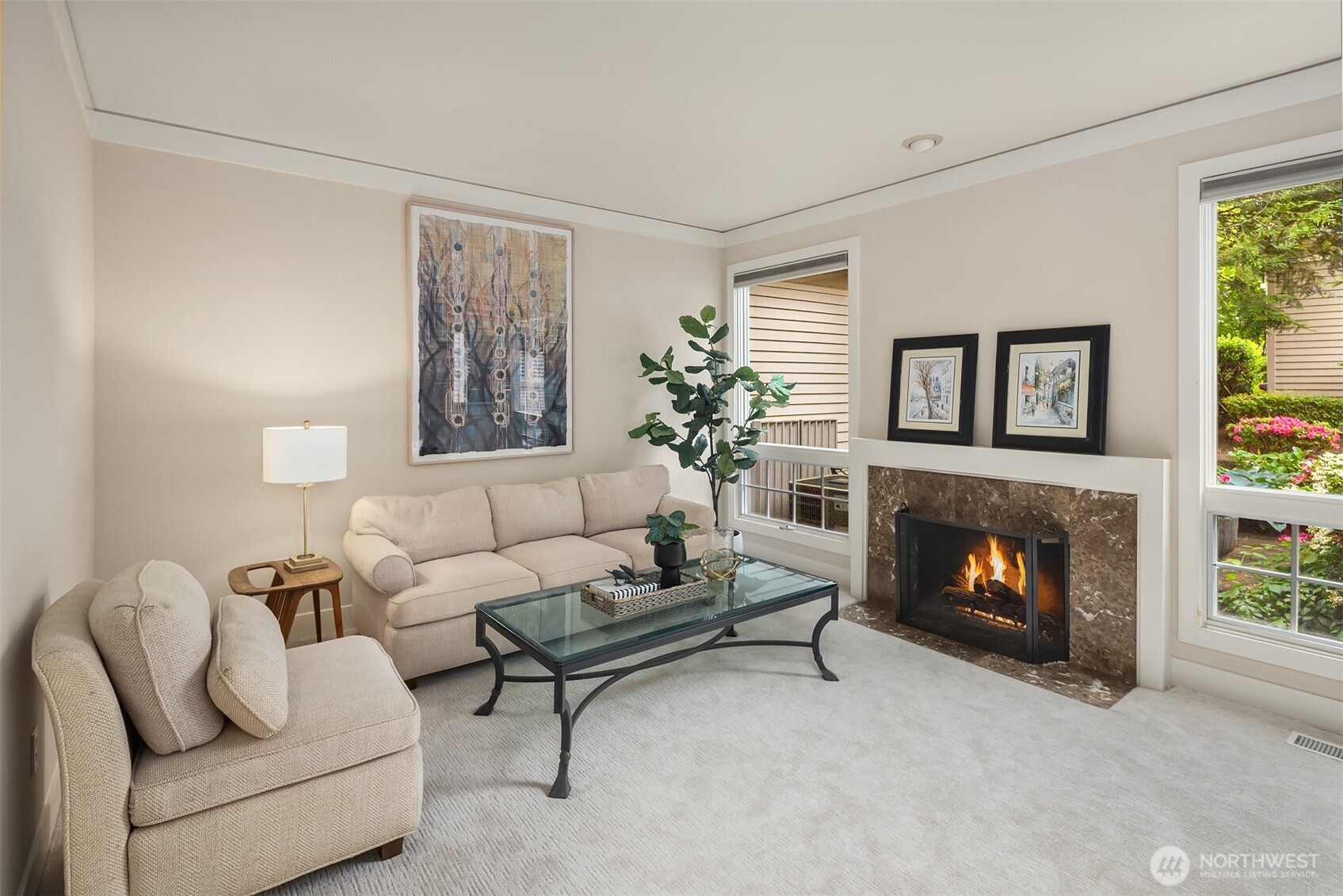 Step inside to a bright & spacious living area featuring vaulted ceilings, large windows & two cozy fireplaces.