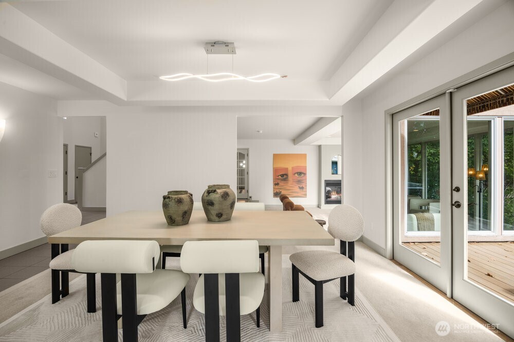 Formal dinning room with doors to the large deck, which is shared with the kitchen with eating space. (1 of 3 decks)