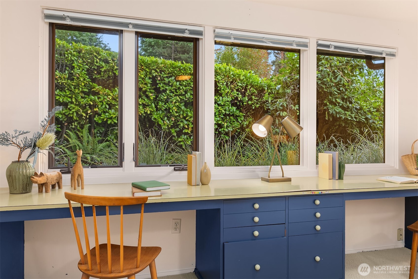 Enjoy sunny workdays at the south-facing built-in desk, with lush hedges and rhododendrons providing peaceful privacy from the street.