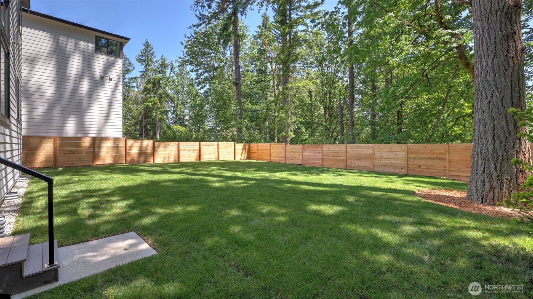 Just steps down from the deck and Main Level, relax to the serenity of the wonderful backyard.