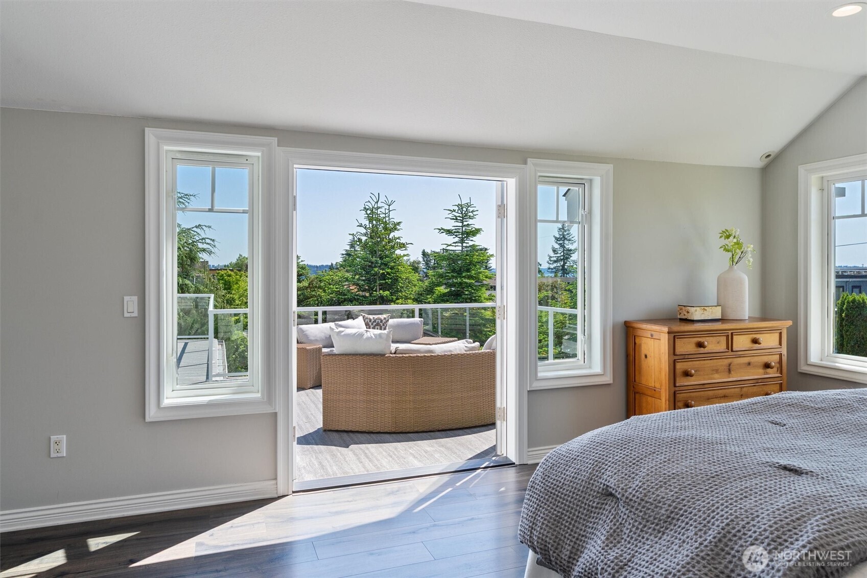 Wake up to breathtaking views in the primary suite that opens to a vast deck.
