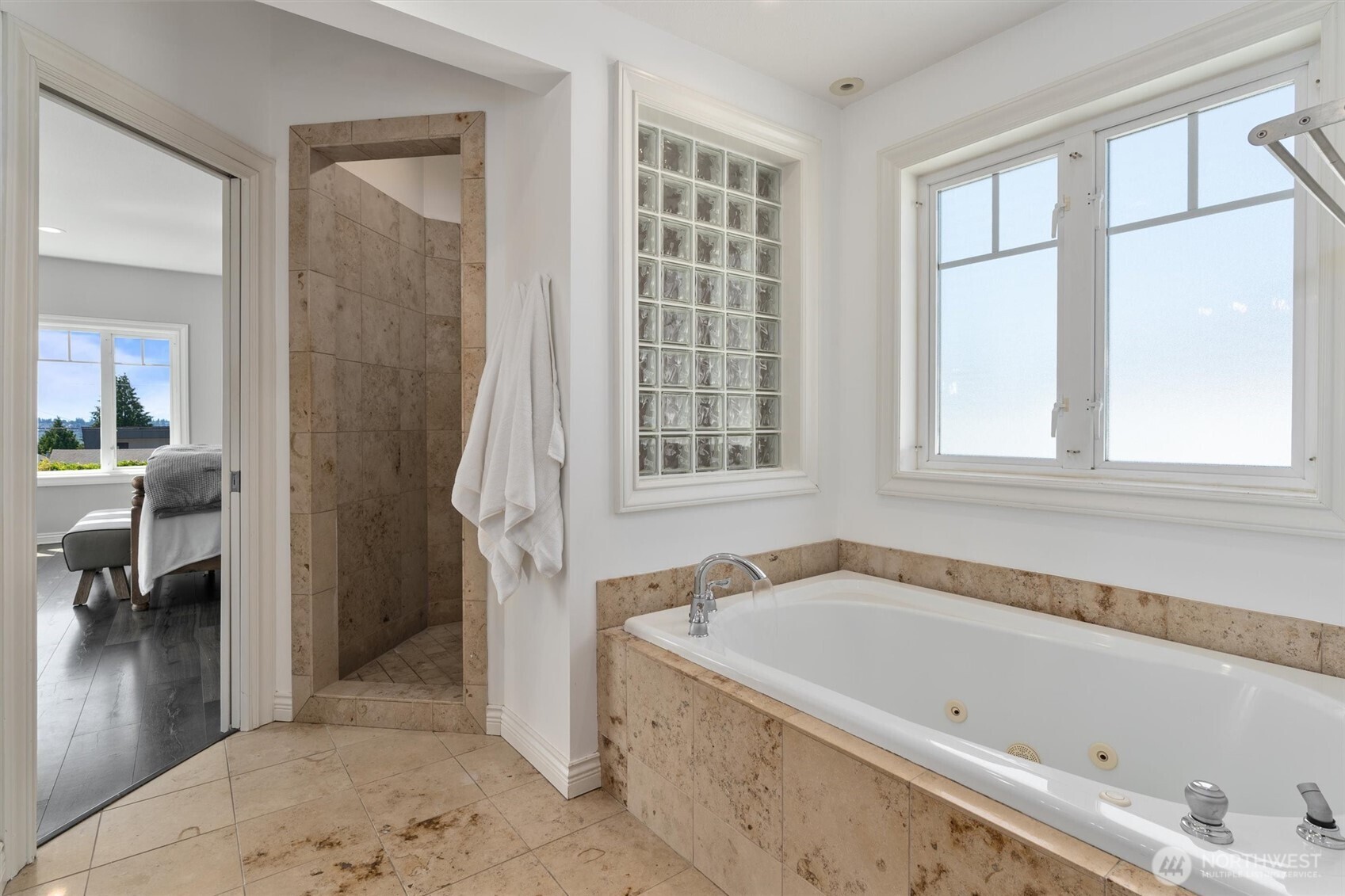 Relax in the soaking jetted tub and shower surrounded by exquisite travertine marble.