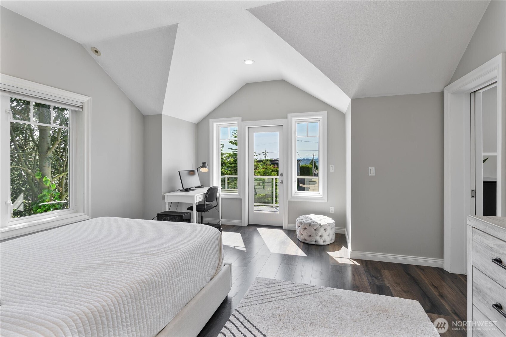 Light-filled en-suite bedroom with vaulted ceilings, private deck access, and a serene work-from-home nook.