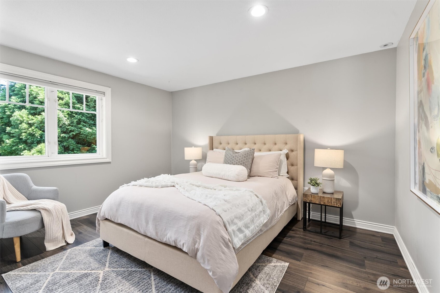 Spacious upstairs bedroom with a picture window and generous closet.