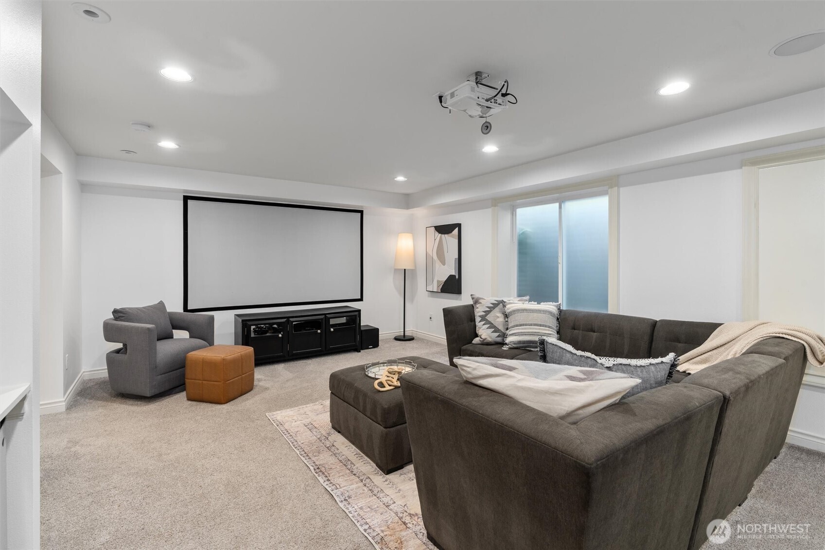 Versatile basement bonus room complete with a movie projector, dedicated bar area, and built-in mini fridge—perfect for entertaining or relaxing in your own home theater.