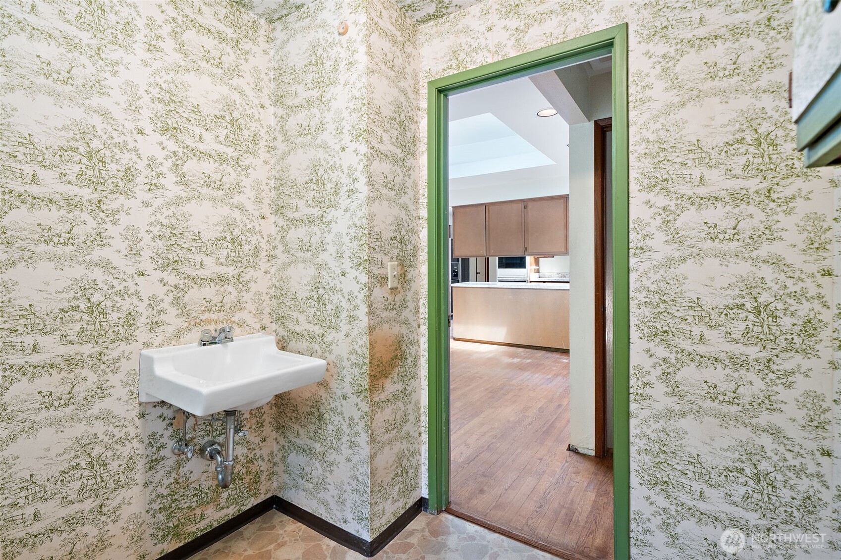 Hall half bath off kitchen eating area and next to the large bedroom - great opportunity to do a remodel and make the large bedroom into a suite by grabbing the small hall & door next to this bathroom - so much potential!