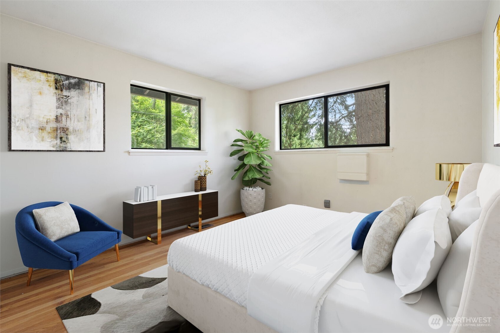 Main level corner bedroom with original hardwood floors. Virtually staged to show potential of this space!