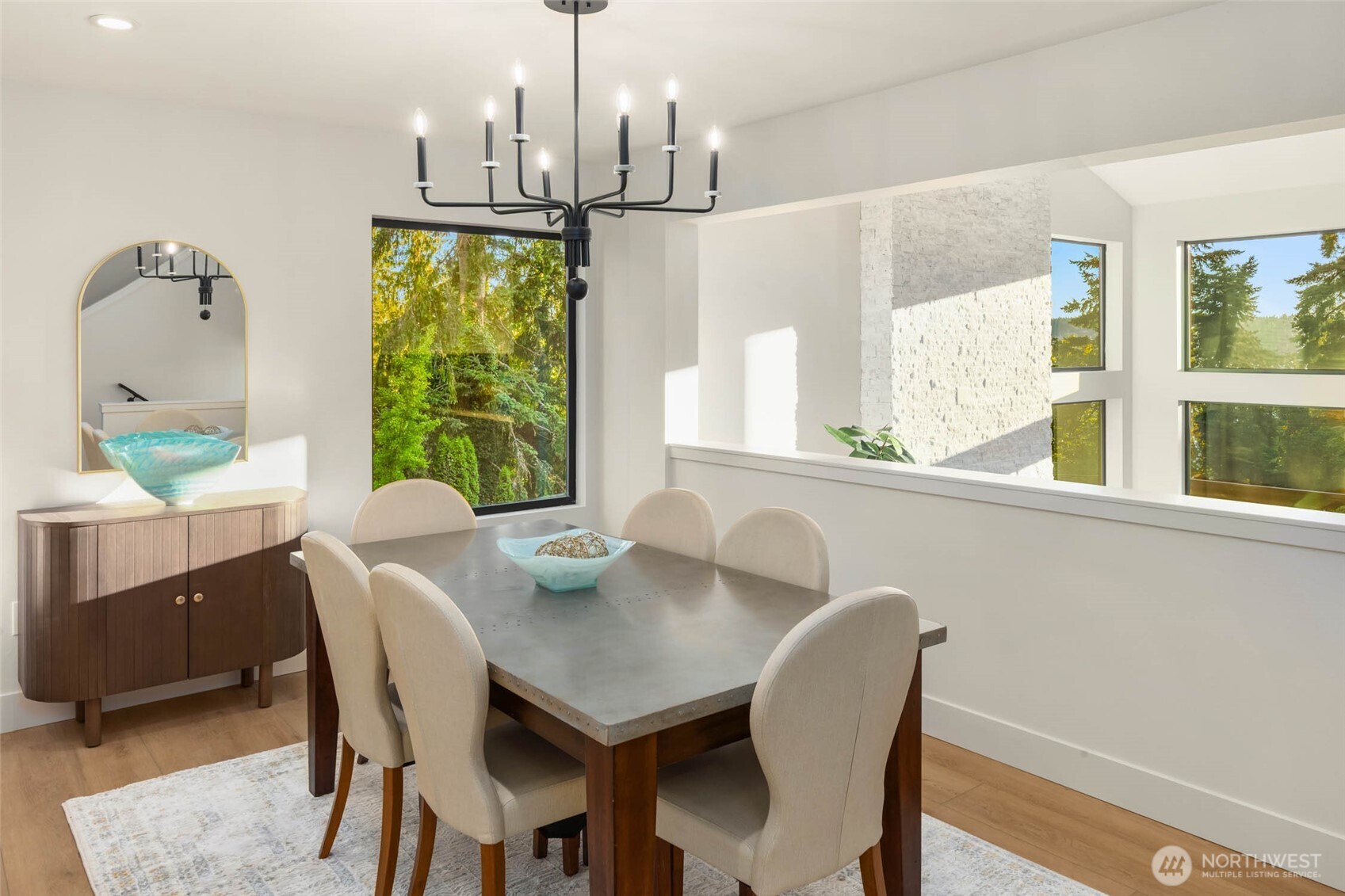 Take in evergreen vistas from this lovely formal dining room overlooking the kitchen and living room below.