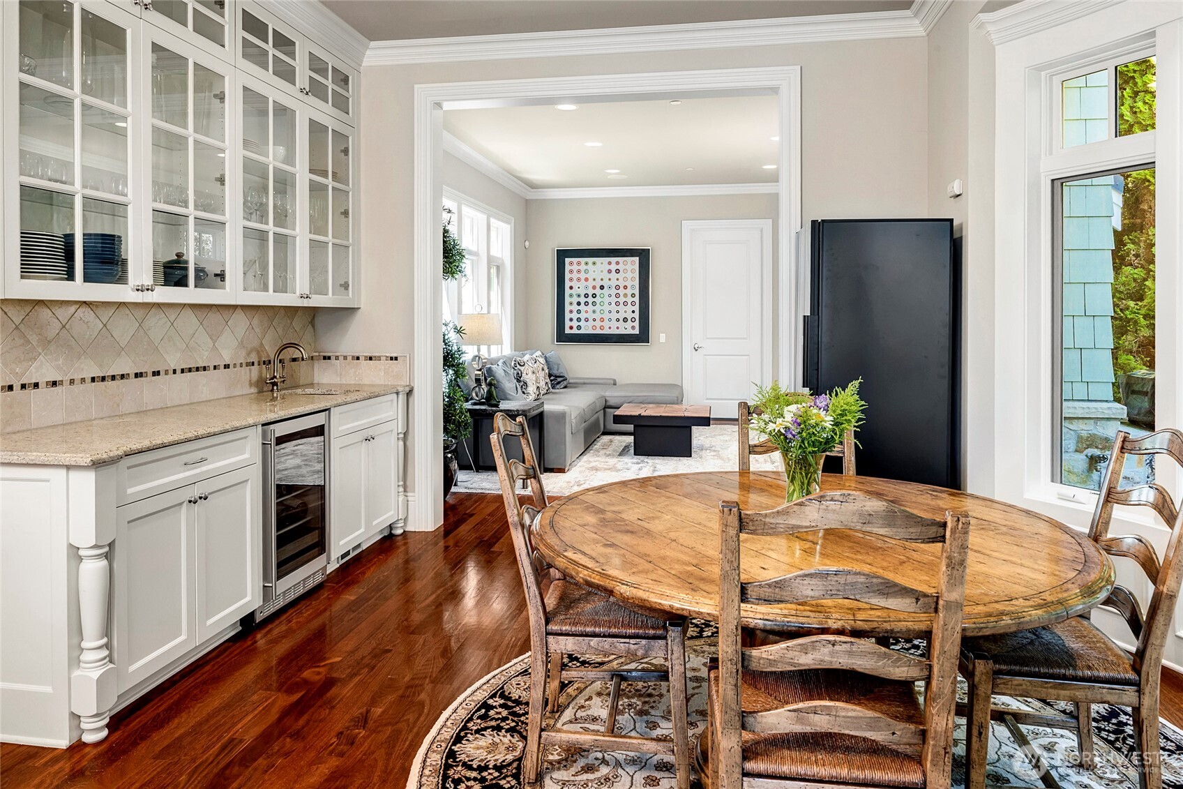 Just off the kitchen sits an eating area with additional storage surrounding a convenient wine fridge.
