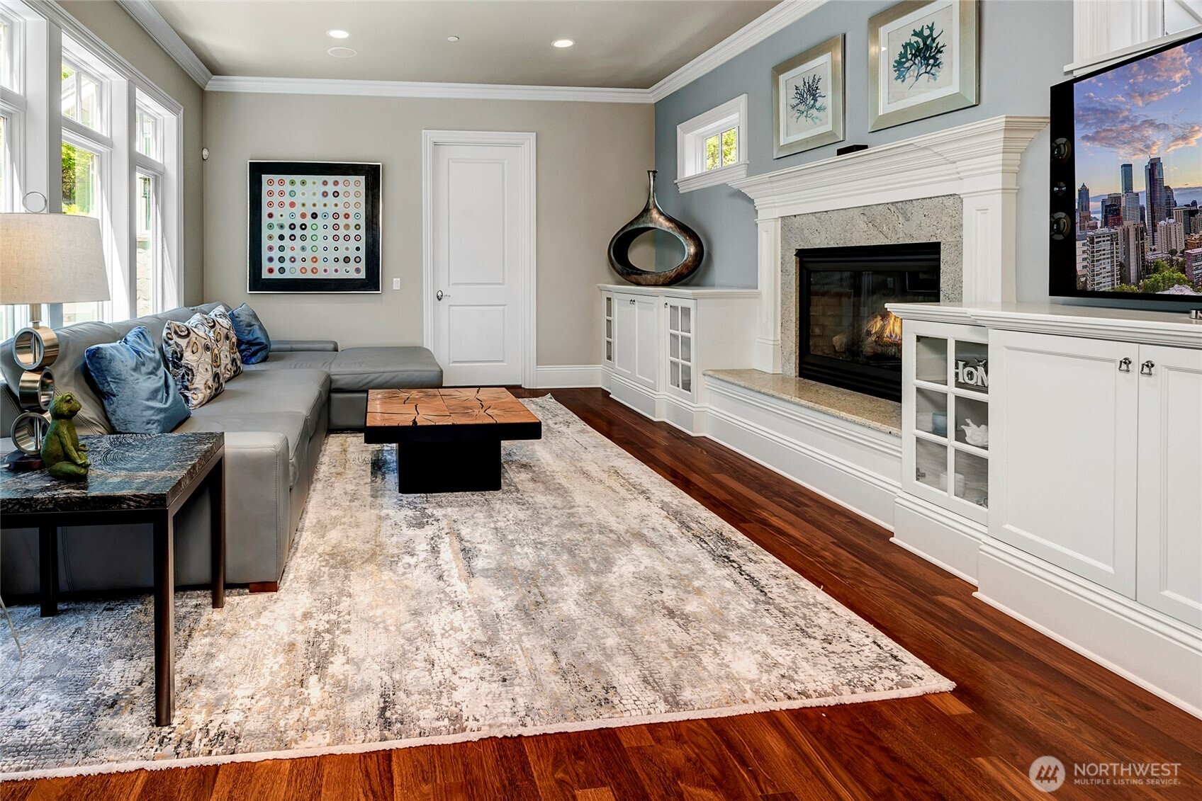 Beyond the eating area is thee family room with the second of 4 gas fireplaces in the home, just before the mudroom and garage entrance.