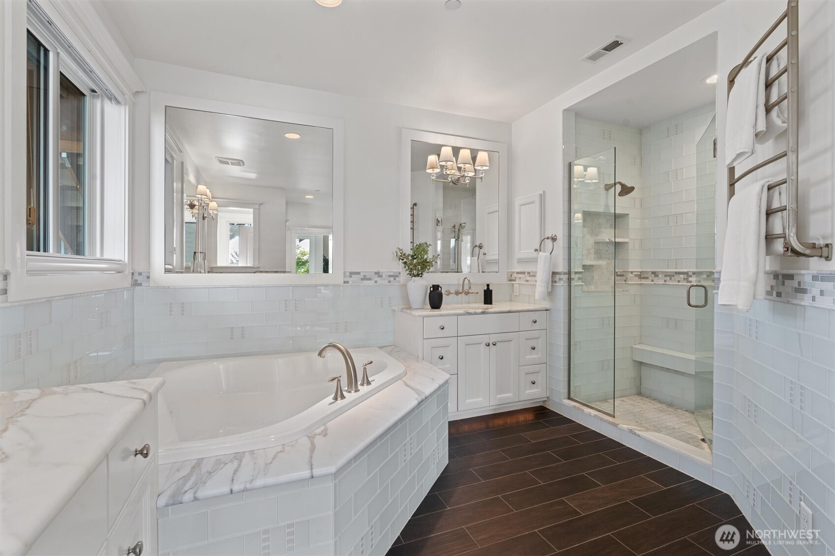 Indulge in a spa-inspired marble bathroom paired with an expansive walk-in closet for ultimate luxury and convenience.