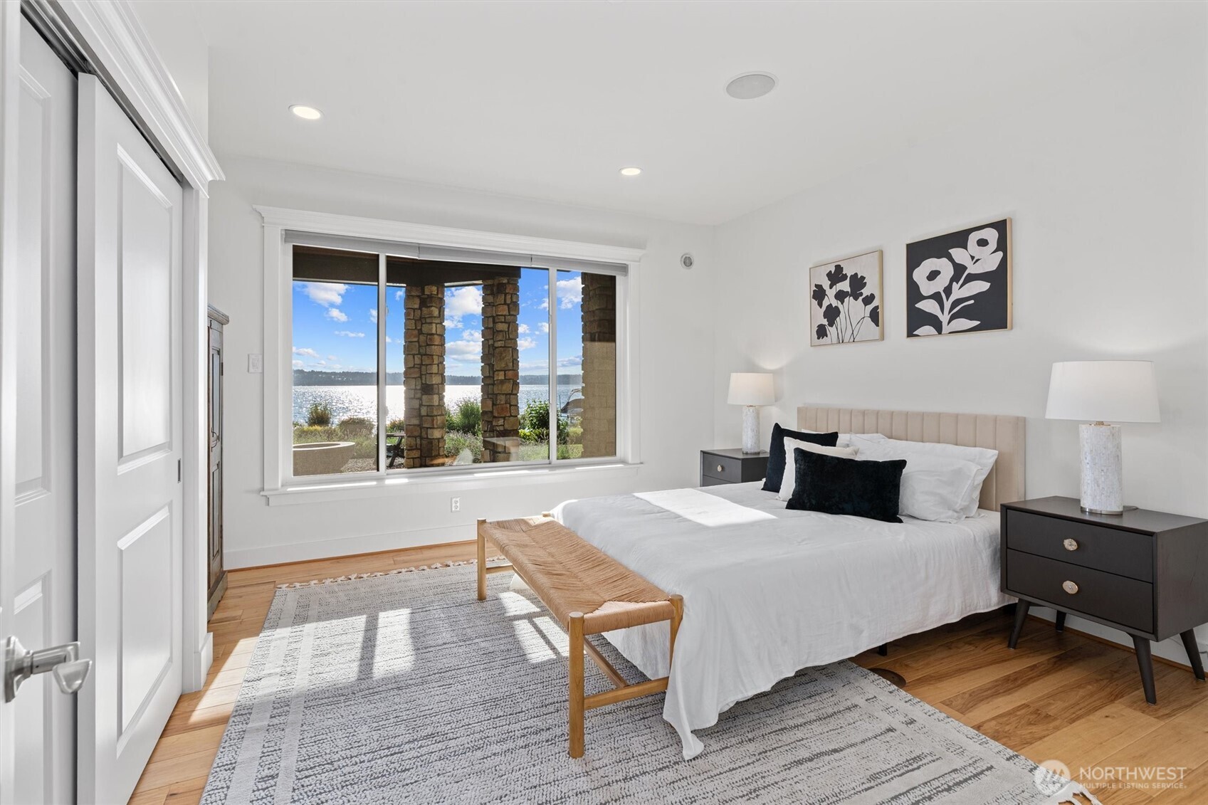 This spacious lower-level bedroom is filled with natural light and captures stunning lake views from oversized windows.