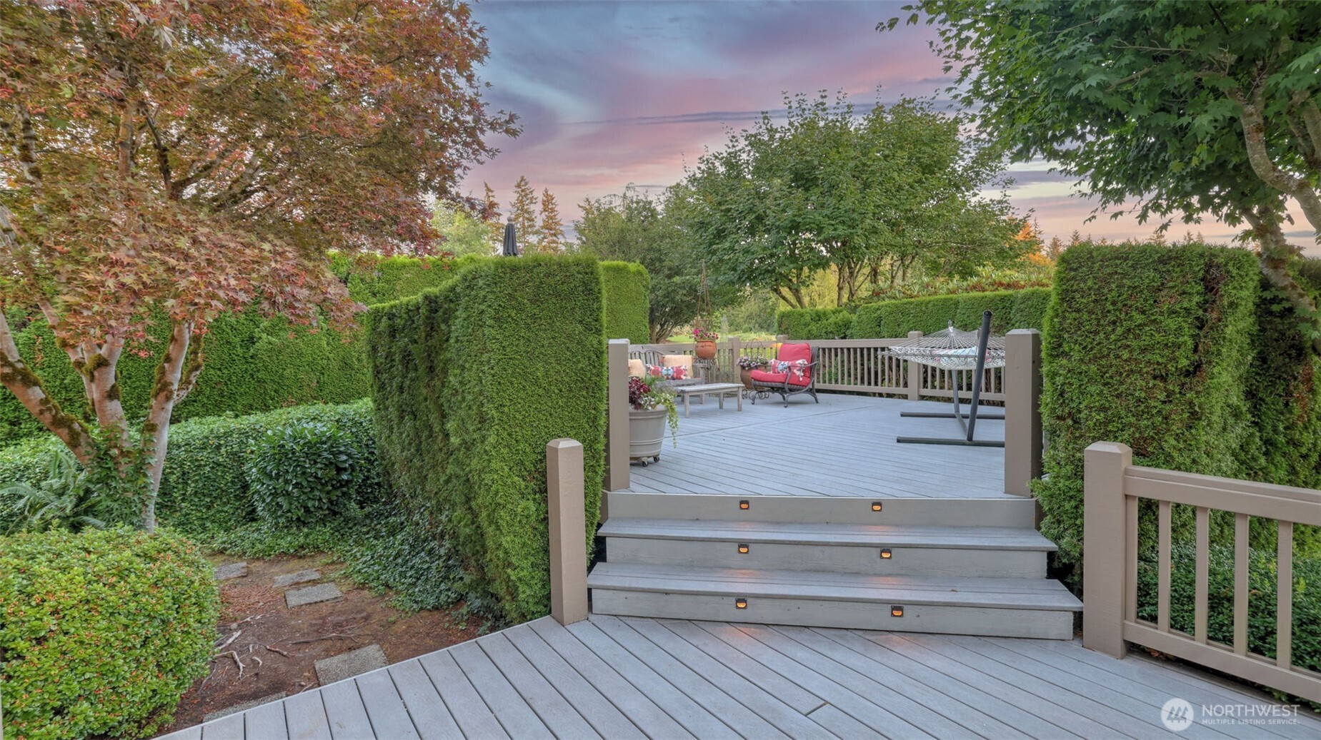 Enjoy your morning coffee on this two-tiered composite deck screened for privacy