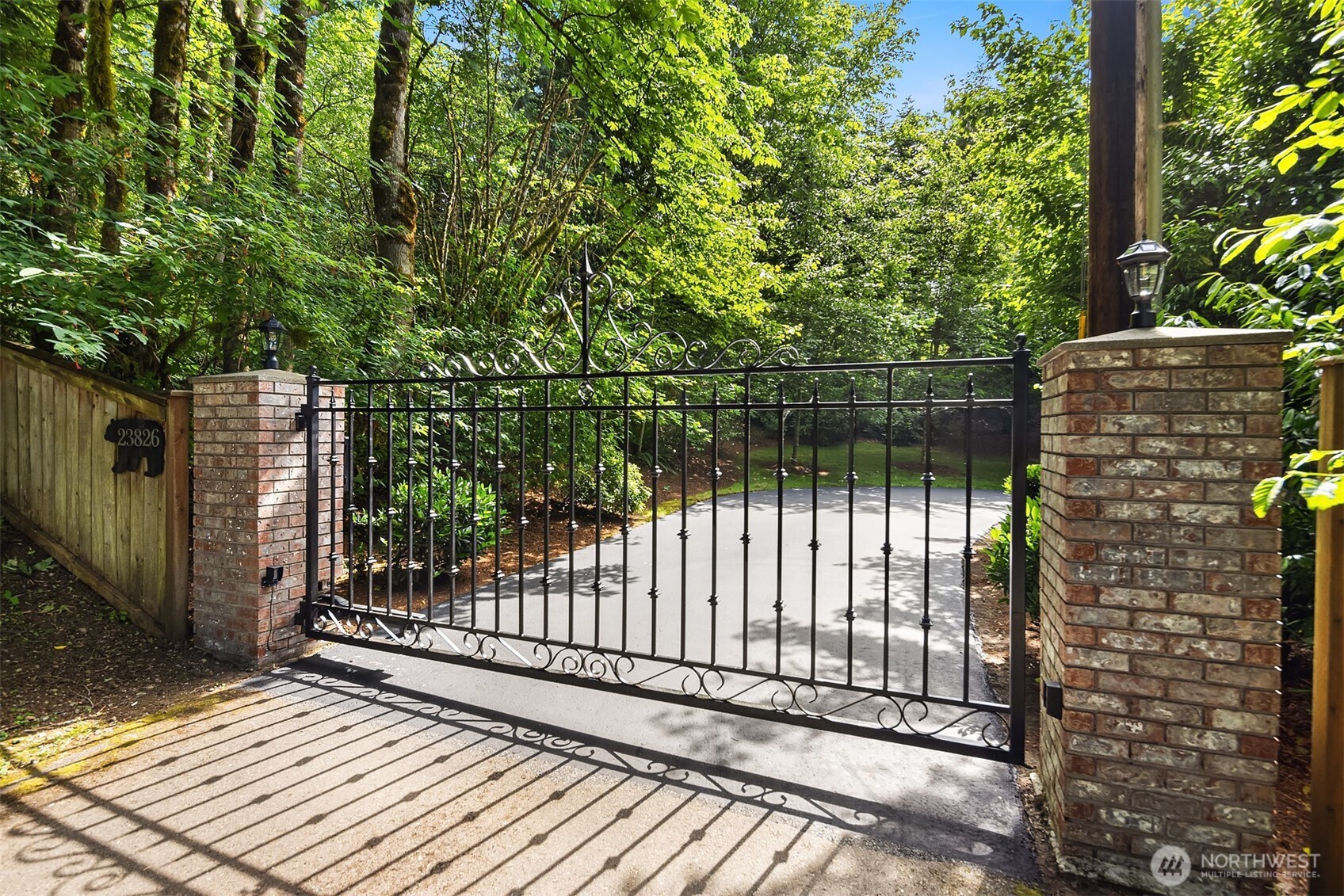 Beautiful entrance with automatic gate and lush grounds.