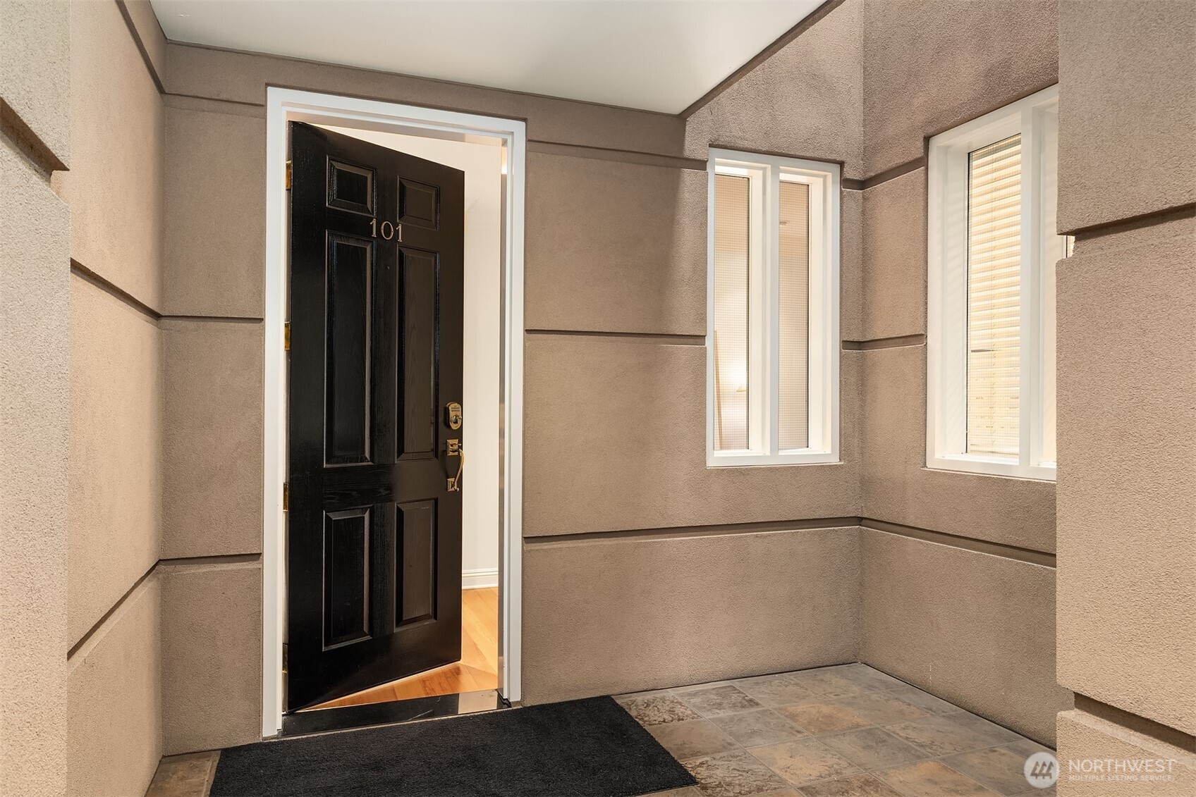 This is the private entrance to this one-story home, just steps from the elevator directly to the secure garage.