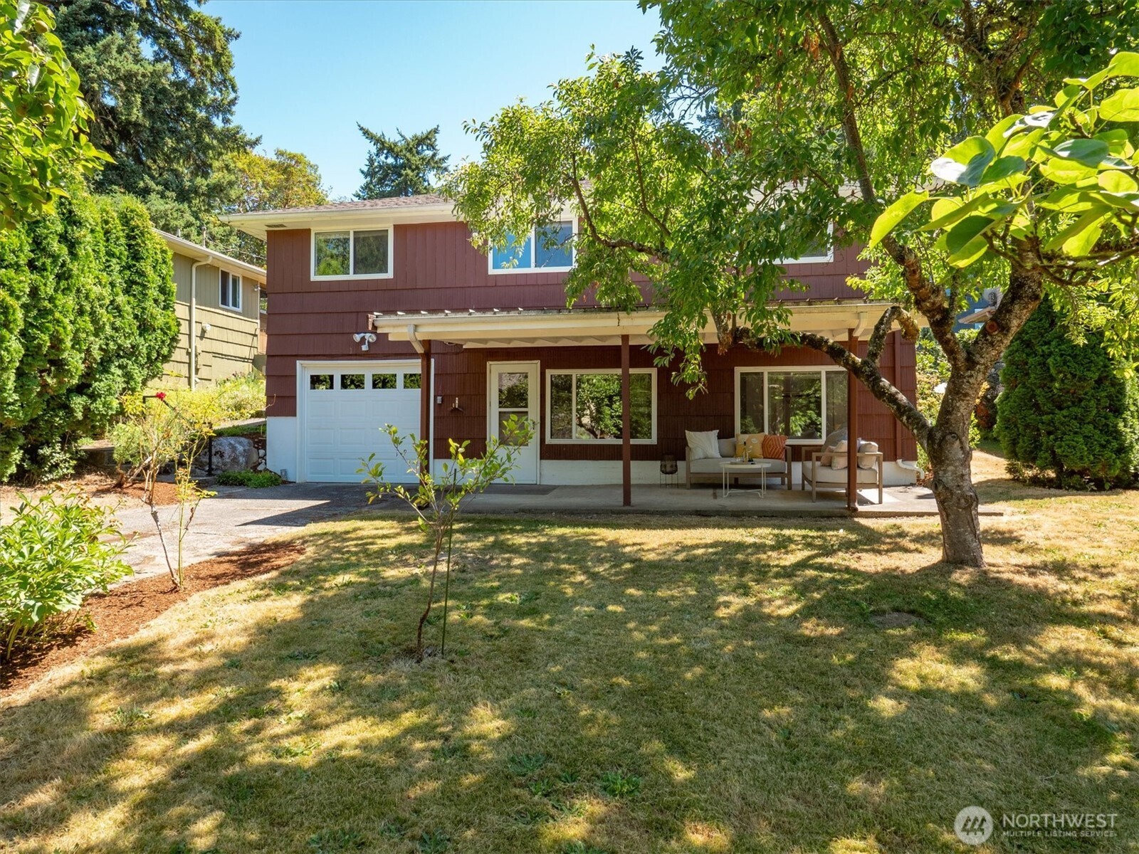 Sumptuous green, natural privacy, and alley access make the case for this delightful backyard.